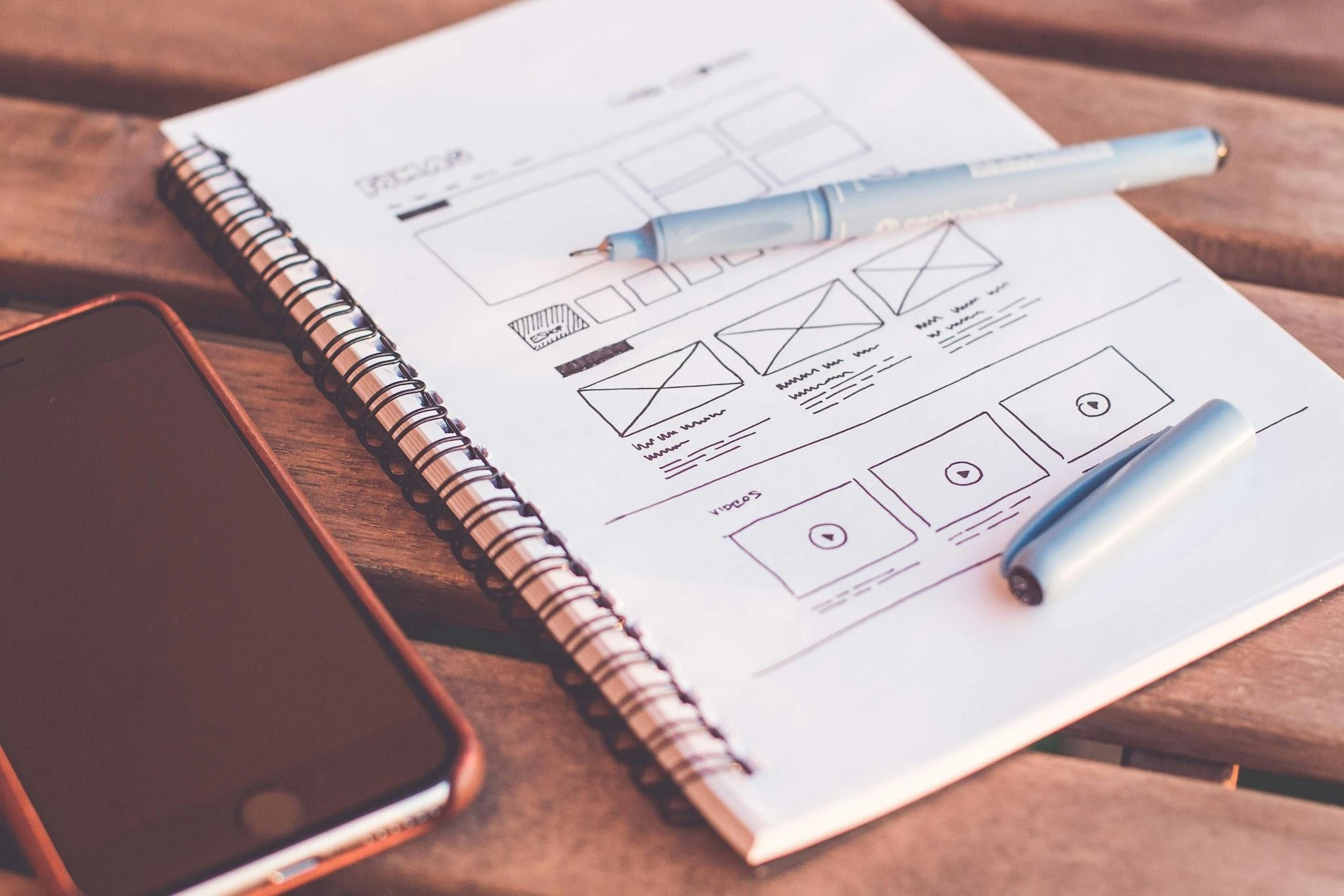 Sketchbook with website wireframes, representative of creative direction and concept development
